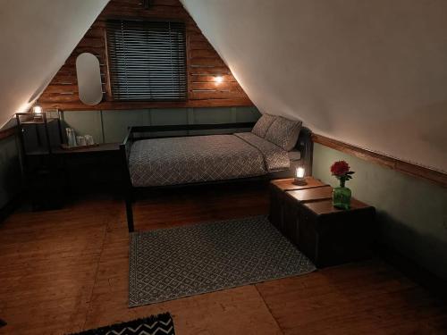a bedroom with a bed and a chair in a attic at Le CLOS SUZANNE in Vesaignes-sous-Lafauche