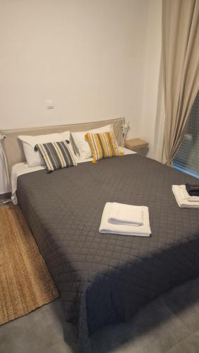 a bedroom with a large bed with a tray on it at Blue view in Skala Rachoniou