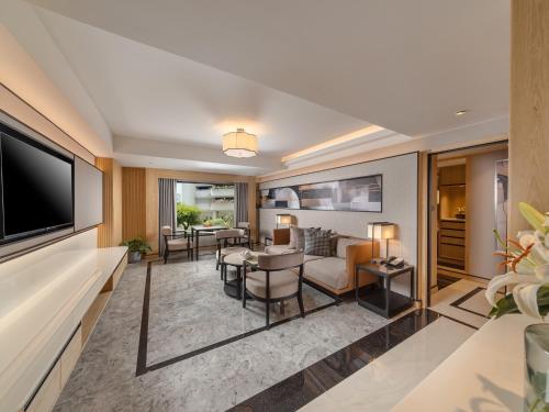 a living room with a couch and a table at Samala Suites Bangkok Sukhumvit 19 by Kingston Hotels in Bangkok