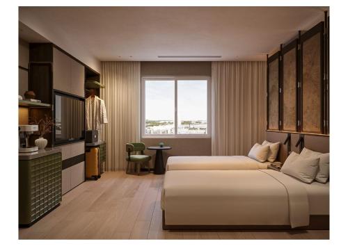 a hotel room with two beds and a window at DUHORÉA Hotel and Wellness in Hanoi