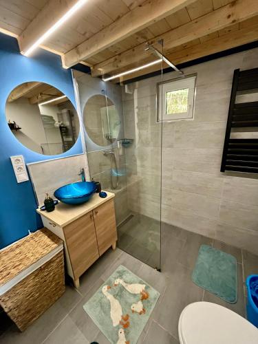 a bathroom with a sink and a glass shower at Berkenye 2621 in Kismaros