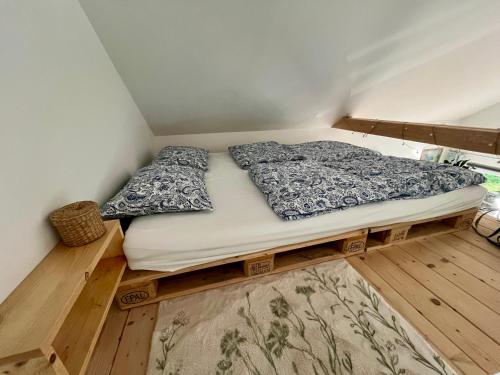 a bed sitting on a wooden platform in a room at Berkenye 2621 in Kismaros