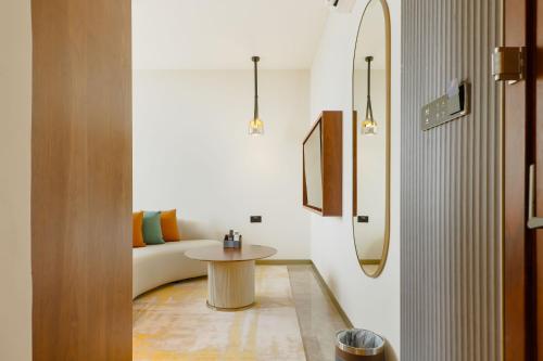 a bathroom with a sink and a table in a room at Abantu Hotel in Dar es Salaam