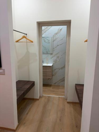 a hallway with a bathroom with a sink and a mirror at Domus Rhegium in Reggio di Calabria