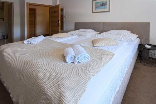 two beds with white towels on top of them at OÁZIS Hotel*** in Nagykanizsa