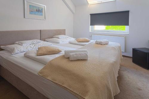 a bedroom with two beds with towels on them at OÁZIS Hotel*** in Nagykanizsa