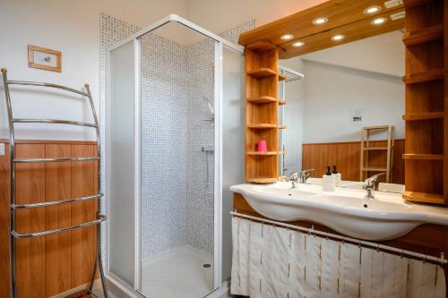 a bathroom with a sink and a shower at Chambres d'hôtes, Les Combes in Orbey