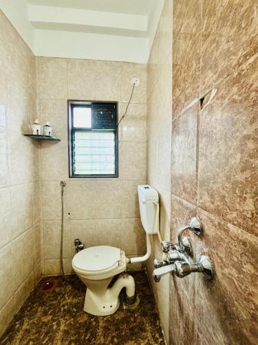 a bathroom with a toilet and a window at Wakad Executive in Méribel Village