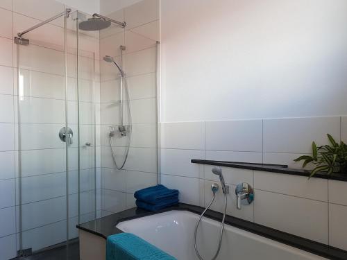a bathroom with a shower and a bath tub at Double room 75 sqm between Augsburg and Munich in Wiedergeltingen
