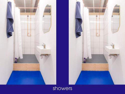 a bathroom with two sinks and two mirrors at NQnap in Manchester