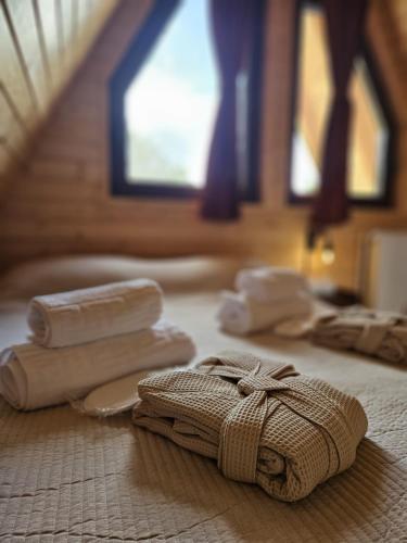a group of towels sitting on top of a bed at Plai cu dor - Brebu in Brebu Mînăstirei