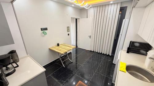 a kitchen with a table and a sink in a room at Villa Guru Efeler in Didim