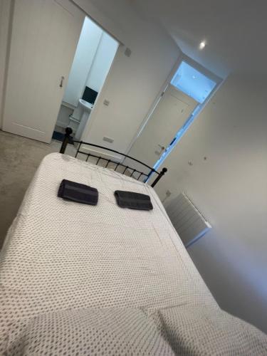 a large bed in a room with a window at 1 Marine House in Penzance