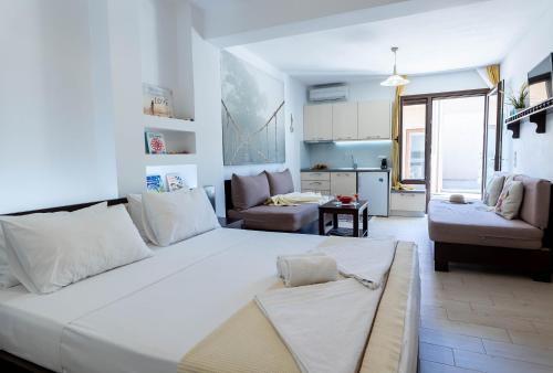 a bedroom with a large white bed in a room at Alex port view apartments in Syvota