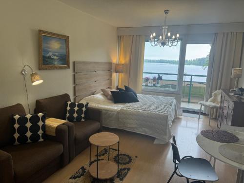 a bedroom with a bed and a living room at Hotelli Terme 111 in Kilvakkala