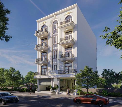 a white building with cars parked in front of it at Hotel Bích Lam in Phong Xá