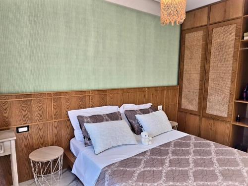 a bedroom with a bed with white sheets and pillows at 60 seconds walk to the Beach in Golem