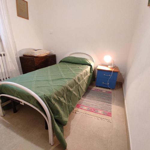 a small room with a bed and a night stand at Tra i Parchi in Pescina