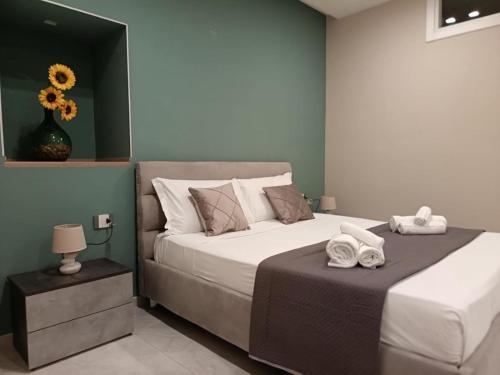 a bedroom with a large bed with towels on it at Terraforte Luxury Suite in Fisciano