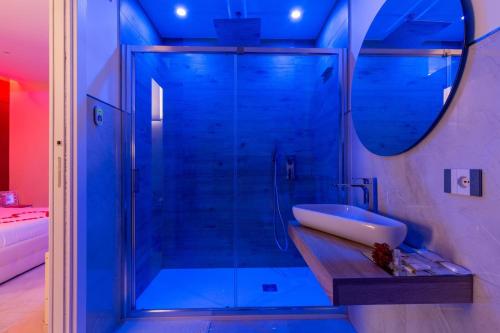 a bathroom with a shower with a sink and a mirror at Terraforte Luxury Suite in Fisciano