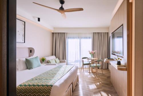 a hotel room with a large bed and a table at Barceló Punta Umbría Mar in Punta Umbría