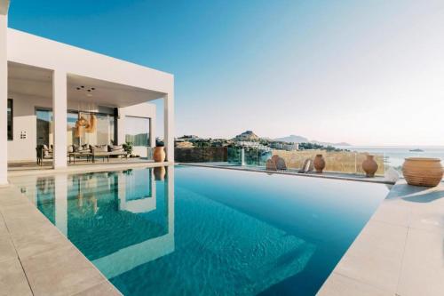 a house with a swimming pool with a view of the ocean at Michelle Villa in vlicha