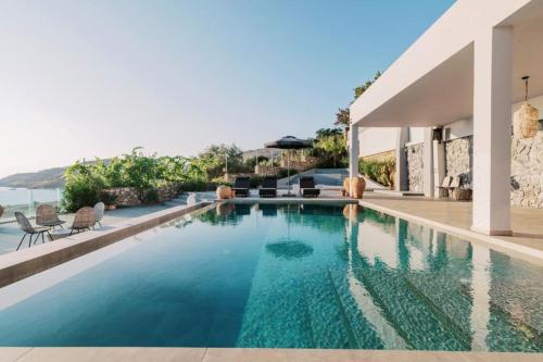 a swimming pool in a villa with a view of the ocean at Michelle Villa in vlicha