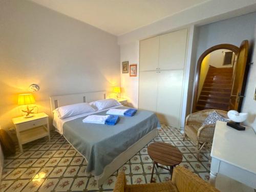 a bedroom with a bed with two towels on it at Villa Azzurra in Conca dei Marini
