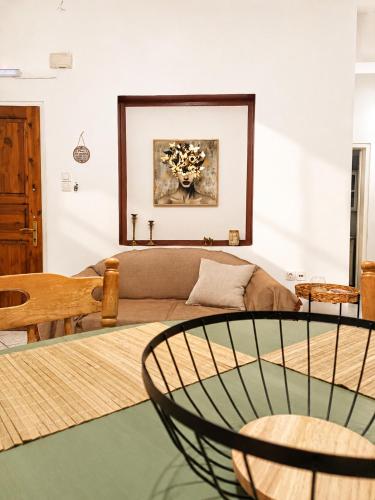 a living room with a couch and a table at Eva's House in Amarynthos