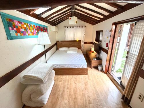 a bedroom with a bed and a lamp in it at Gohyundang in Jeonju