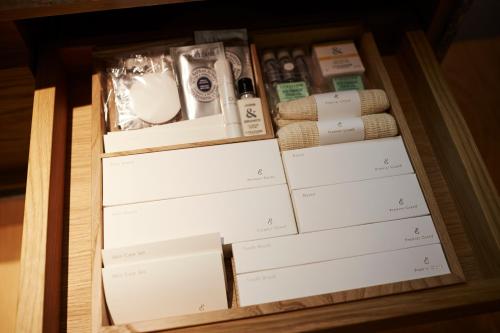 a drawer full of boxes and papers on a table at Keio Plaza Hotel Tokyo in Tokyo