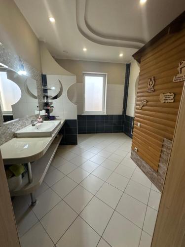 a large bathroom with two sinks and a shower at Арендное жилье Лиманка in Odesa