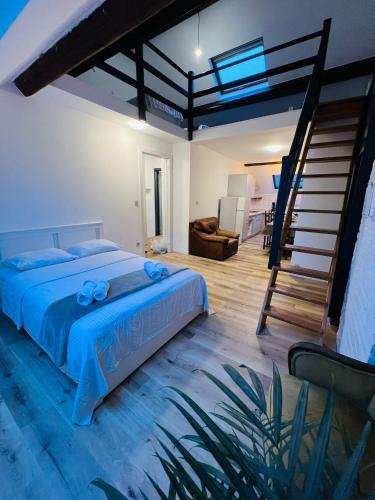 a bedroom with a blue bed and a staircase at Albergue Bosquet in Brussels