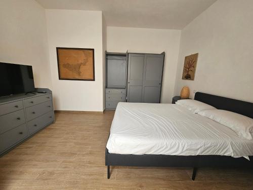 a bedroom with a bed and a flat screen tv at Teseo Holiday in Castelvetrano Selinunte