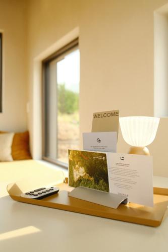 a wooden tray with a remote control on a table at Oseraie Cabins - Wild lodges entre Liège et Maastricht in Visé