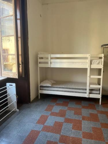a white bunk bed in a room with a window at Coremi Naples in Naples