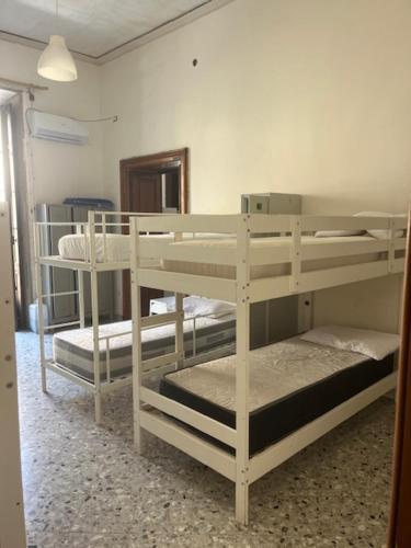 a room with three bunk beds in a room at Coremi Naples in Naples
