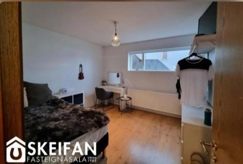 a bedroom with a bed and a desk in it at Great place to see the solar eclipse! in Patreksfjörður