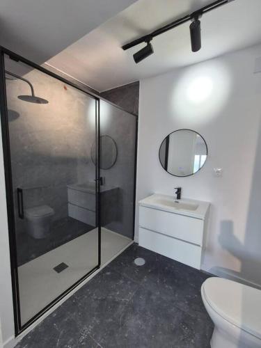 a bathroom with a shower and a toilet and a sink at Suite con Vista a las Islas Cies in Vigo