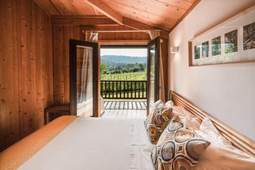 a bedroom with a bed with a view at Quinta Lamosa Agroturismo in Arcos de Valdevez