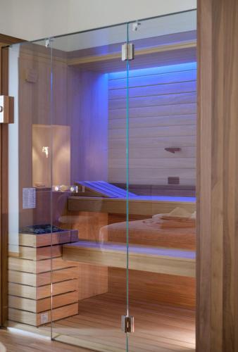 a room with a bed and a glass wall at Benedamò Home Inside in Polignano a Mare