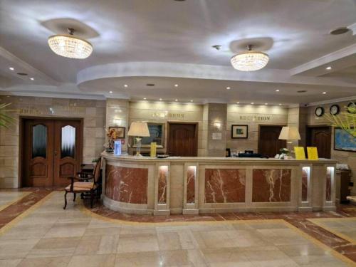 a lobby of a hotel with a reception counter at Danube Hotel & Spa in Silistra