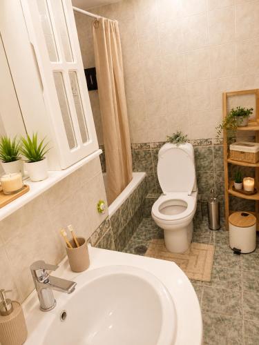 a bathroom with a white sink and a toilet at Eva's House in Amarynthos