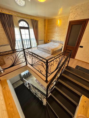a bedroom with a bed and stairs in a room at Family House in Sevan