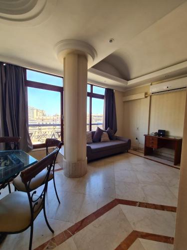 a living room with a couch and a table at suites in cairo downtown in Cairo