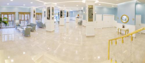 a large room with a lobby with white floors and blue walls at Bursa Palas Hotel in Bursa