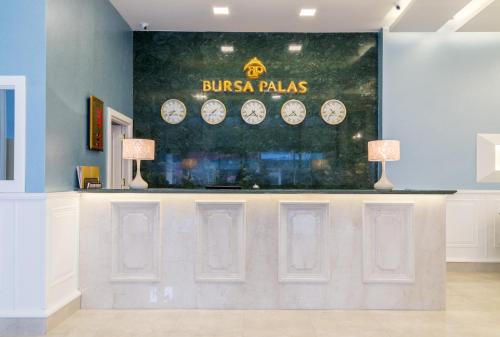 a store counter with clocks on the wall at Bursa Palas Hotel in Bursa