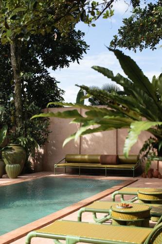 a swimming pool with lounge chairs next to a swimming pool at Moon Gang Ubud in Ubud