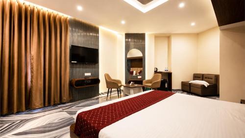 a hotel room with a bed and a desk at Jowar Hotel & Resort in Digha