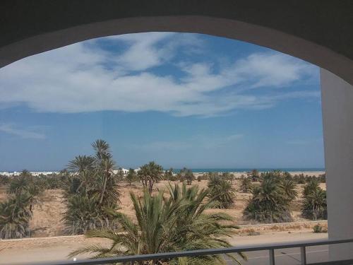 a view of the beach from a window at Résidence PHILA Djerba in Djerba